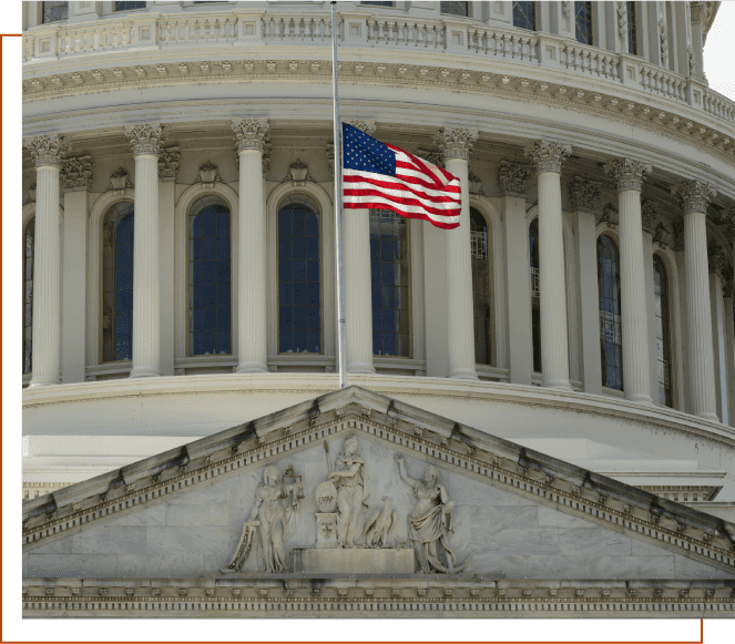 A flag is flying at half-staff in front of the capitol building.